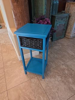 Small teal side table with basket