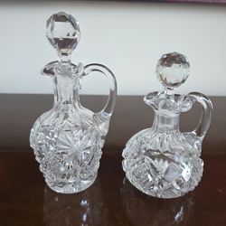 Pair of Bohemian cut crystal cruets with faceted stoppers and applied handles