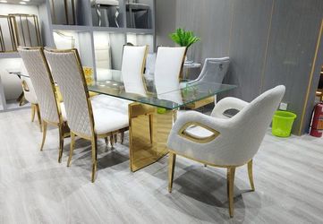 Spectacular dining set. Table with gold details and 6 chairs available in gray and black. Ask for total price. $100 Down Payment