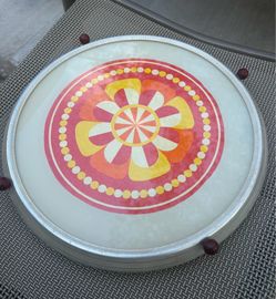 This vintage revolving cake stand features a vibrant flower power pattern