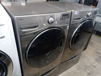 LG gray front load washer and gas dryer set on pedestals - Free delivery
