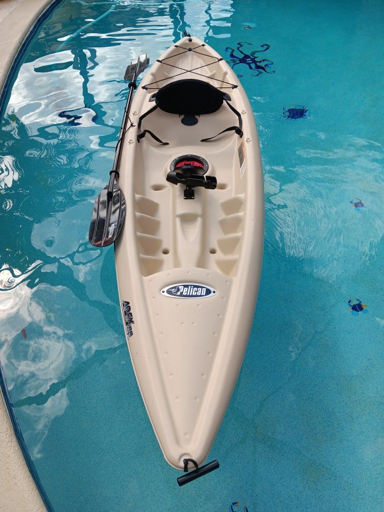 Pelican Apex 100 Angler kayak with paddle.