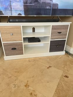 Beautiful white tv stand with cubbies.