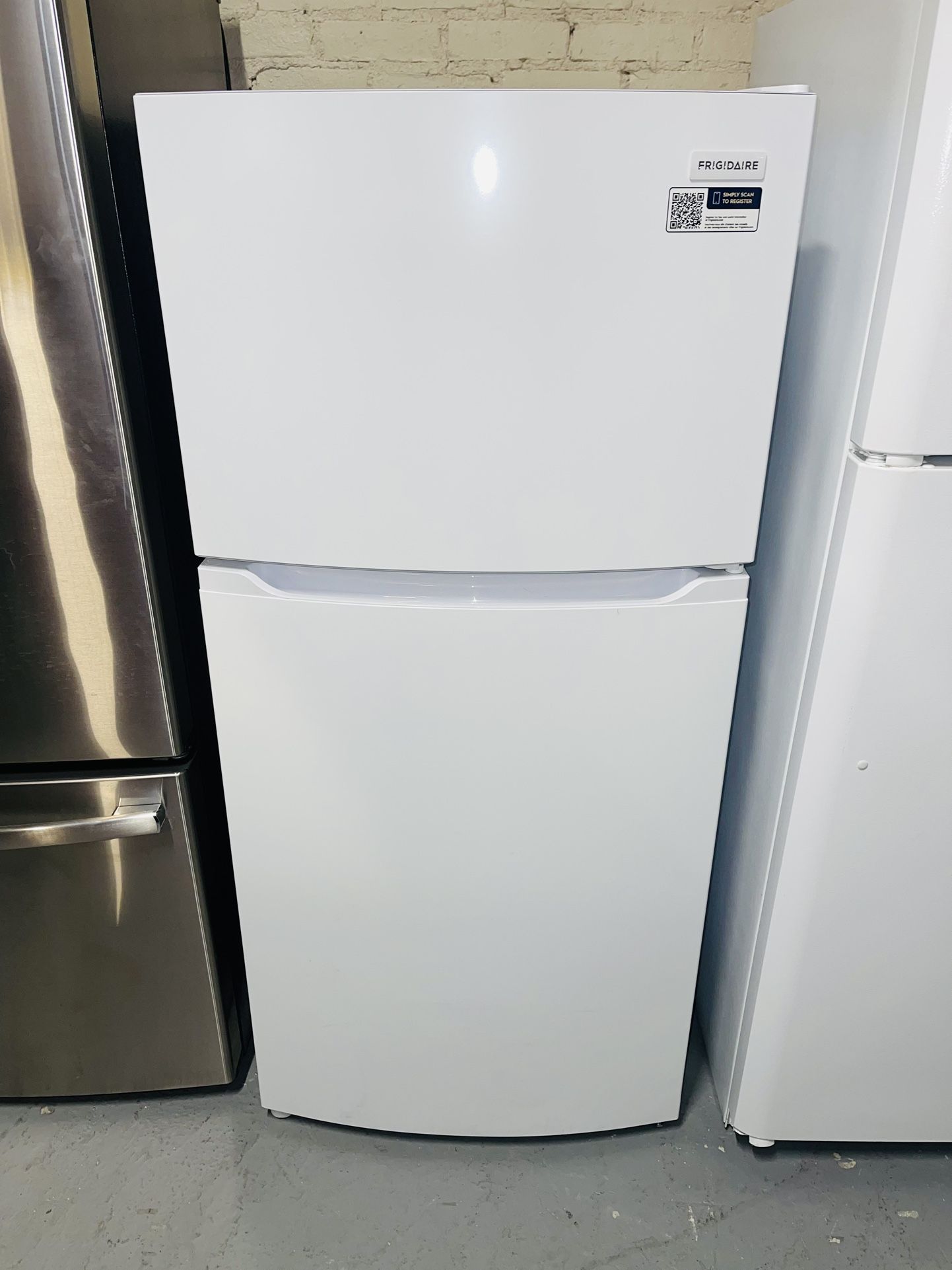 New white Frigidaire refrigerator with a receipt for a 90-day warranty