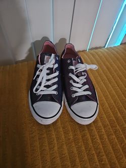 These are Converse Chuck Taylor All Star low-top sneakers in a purple glitter finish