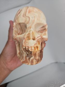 Crystal carving SKULL (Red banded Calcite) also known as Pork Stone