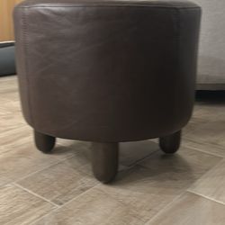 Four Hands Round brown leather ottoman 