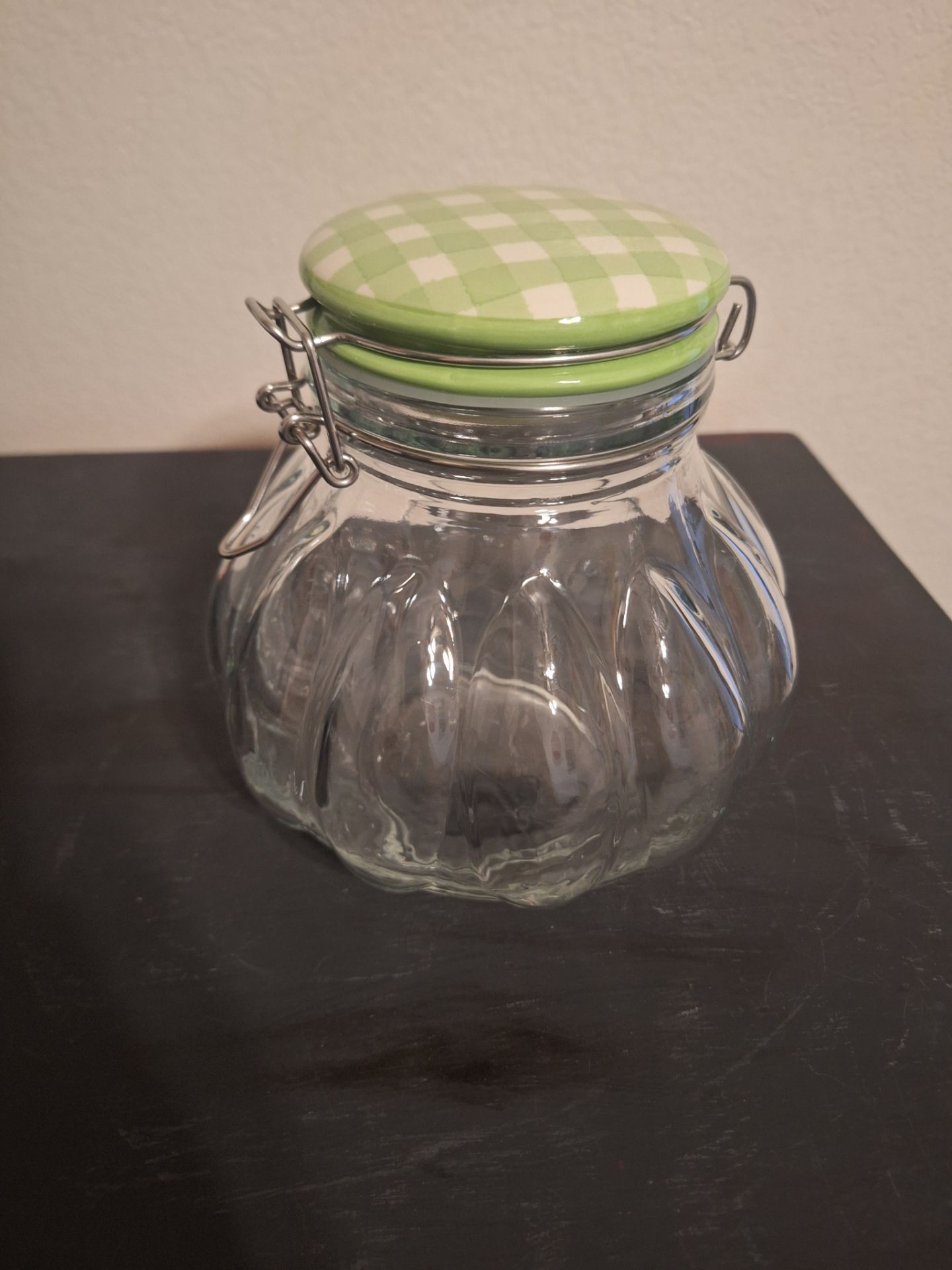 Glass storage jar with green checkered lid