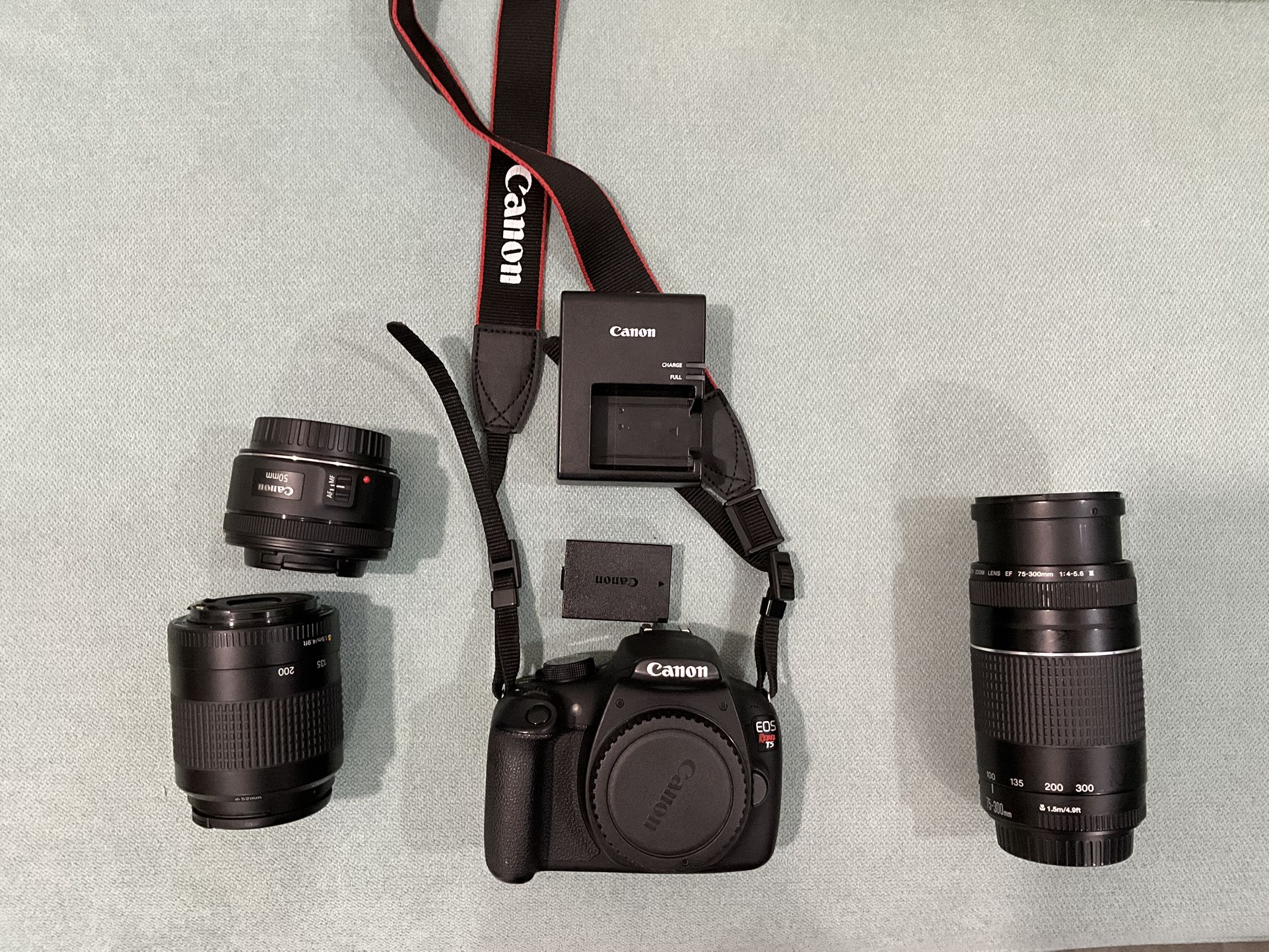 Canon EOS Rebel T5 18.0 MP DSLR Camera with 50 mm, 80-200 mm And 75-300 mm Lens.