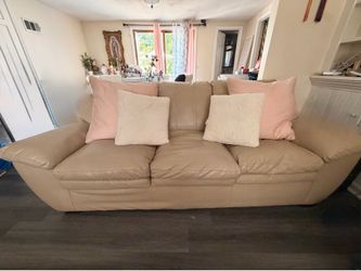 Large leather couch w/pink pillows
