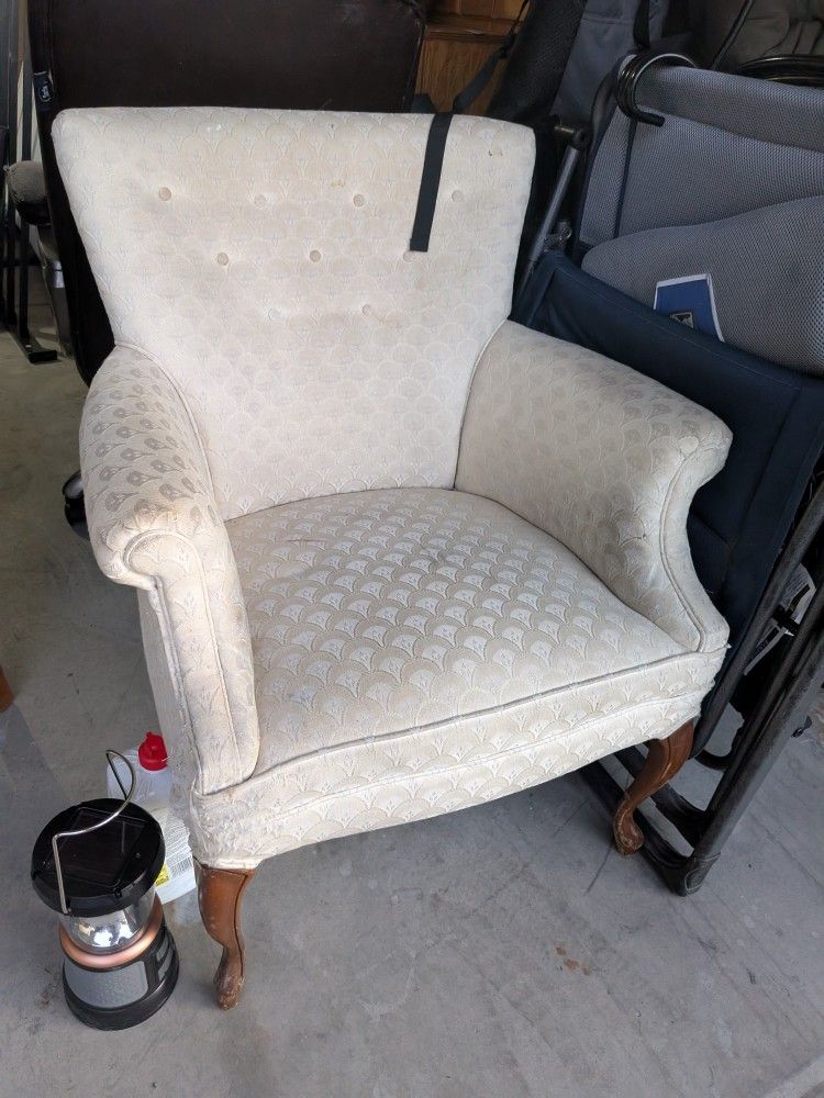 Vintage-style upholstered accent chair with a high, slightly flared back and classic rolled arms