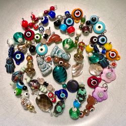Bundle of different glass, stone or shell charms, many in pairs