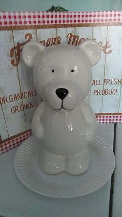 White ceramic teddy bear piggy bank 10 1/2 inches tall has plug on bottom.save your change.