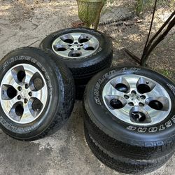 Five used tires with rims for a Jeep. $400.00. Serious inquiries only.