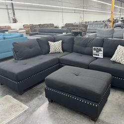 BLACK SECTIONAL SOFA WITH OTTOMAN. REVERSIBLE CHAISE 