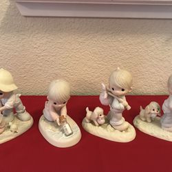 A group of 4 vintage Precious Moments figurines 