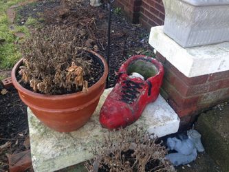 Red planter that's a concrete shoe