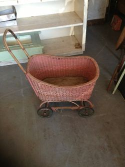 Antique pink wicker baby stroller