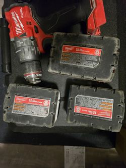 For sale: Milwaukee M18 FUEL combo kit including a hammer drill, impact driver, charger, and 3 batteries
