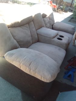Two love seat couches that recline