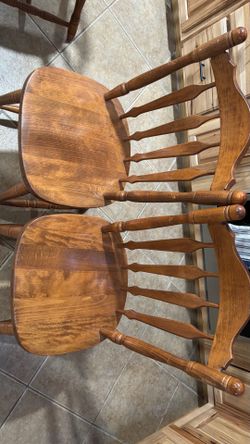Two solid wood chairs.