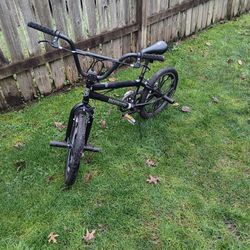 Black mongoose racing bike with pegs and 20" tires 