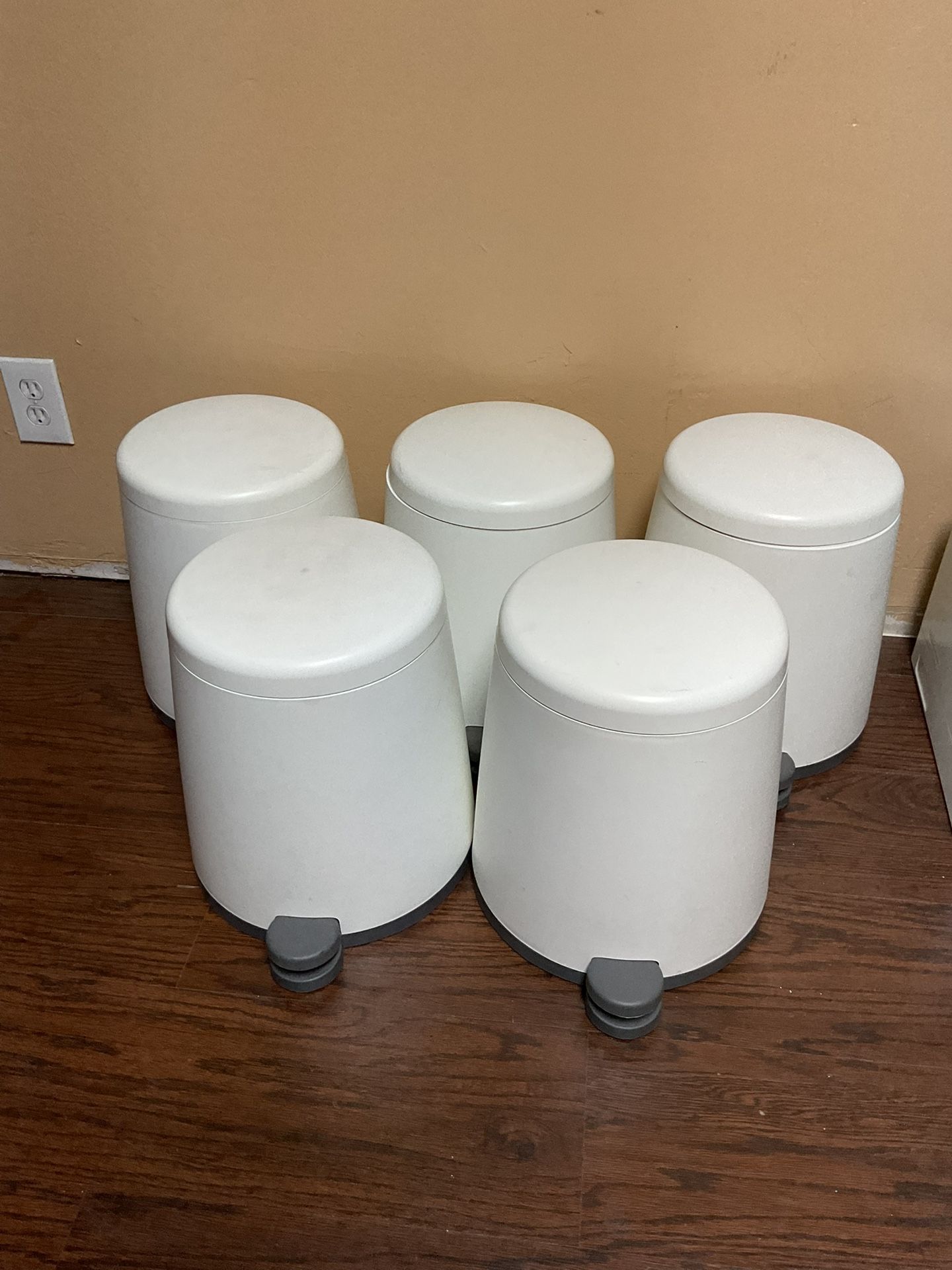 5 small white trash cans