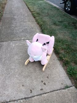 A little kid's Pink n a t t o u rocking horse