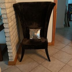 Black Plush Contemporary Wing Chair With Dark Brown Curved Wooden Legs.