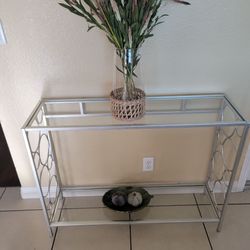 Silver Metal and Glass Console Table. Decorations (NOT included) $50.00