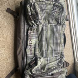 Large Dakine travel bag with plaid design and multiple compartments. Great for skiing snowboarding t