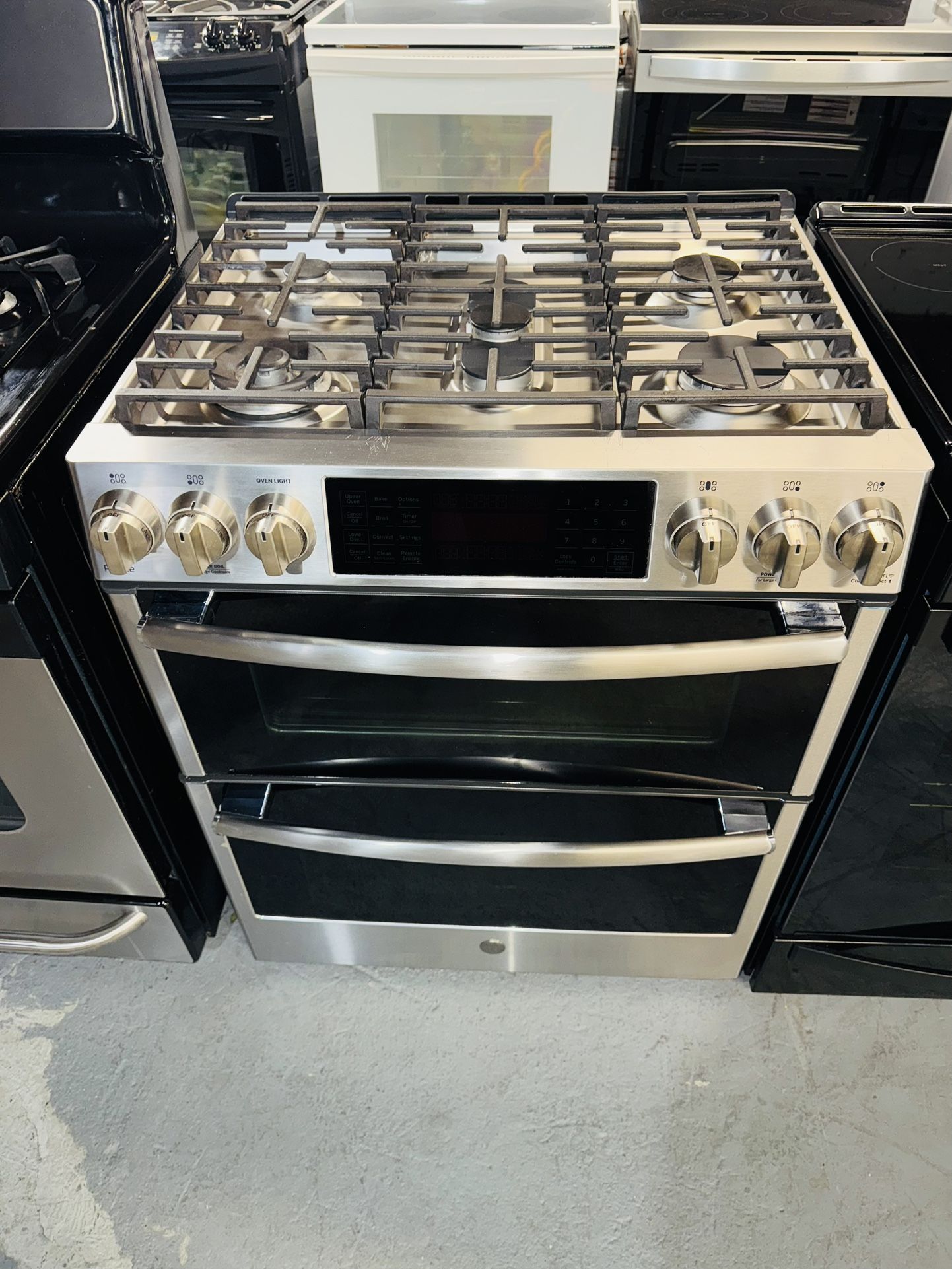 GE stainless steel stove with a receipt for a 90-day warranty