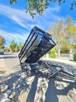 NEW DUMP TRAILER 12X8X4 12000 LBS
ROLLING TARP--SPARE TIRE,ELECTRIC BRAKES,HYDRAULIC SYSTEM,REMOTE CONTROL,IDEAL FOR HAULING, DEMOLITION, TRASH ETC,
