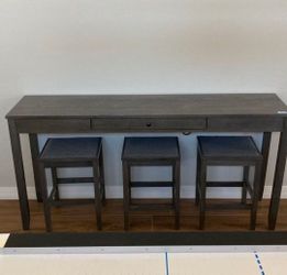 Ashley Furniture Gray Console Table with 3 Stools and Drawer.