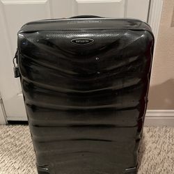 Durable black Samsonite suitcase with wheels.