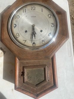 vintage Centurion 31-day mechanical drop-octagon wooden wall clock with a pendulum window below.