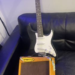 electric guitar and amp with cords 