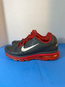 Sneakers — Nike Air Max 2011 in the "Dark Grey/Action Red" colorway.