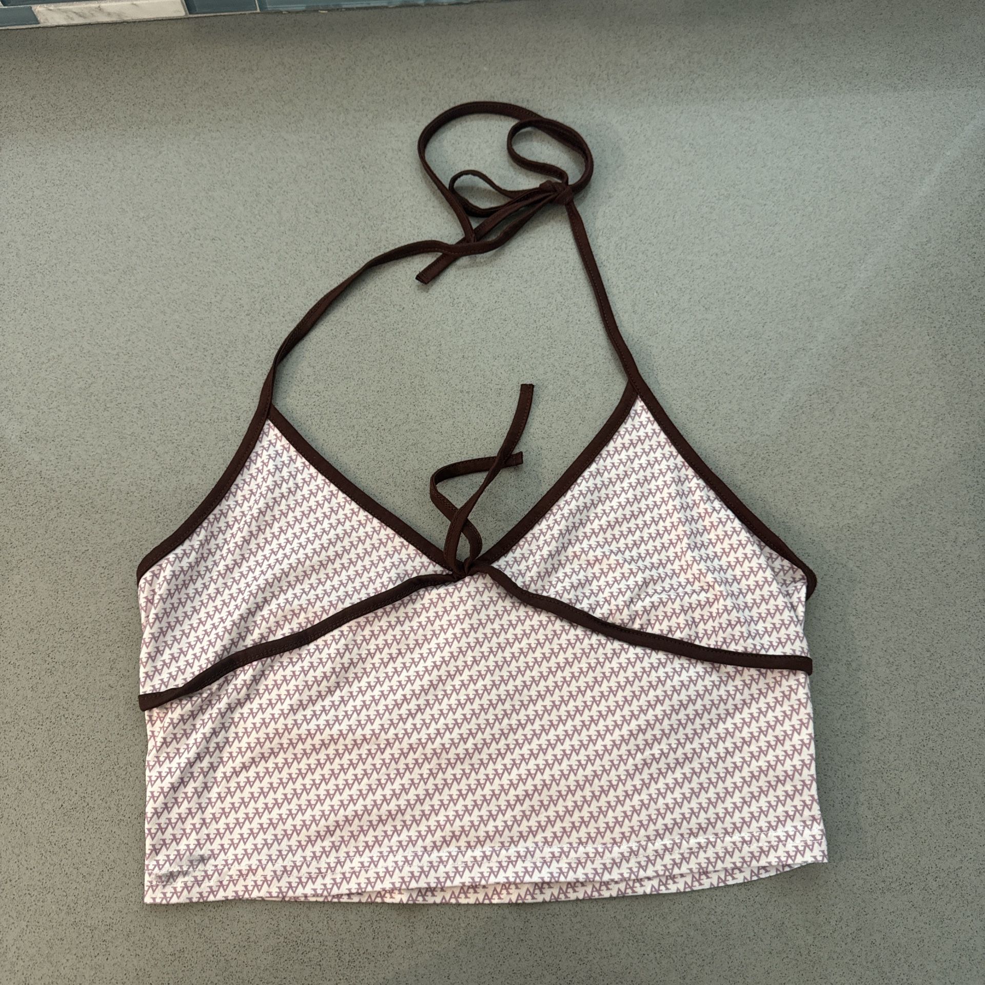 White halter top with brown outline and purple details 