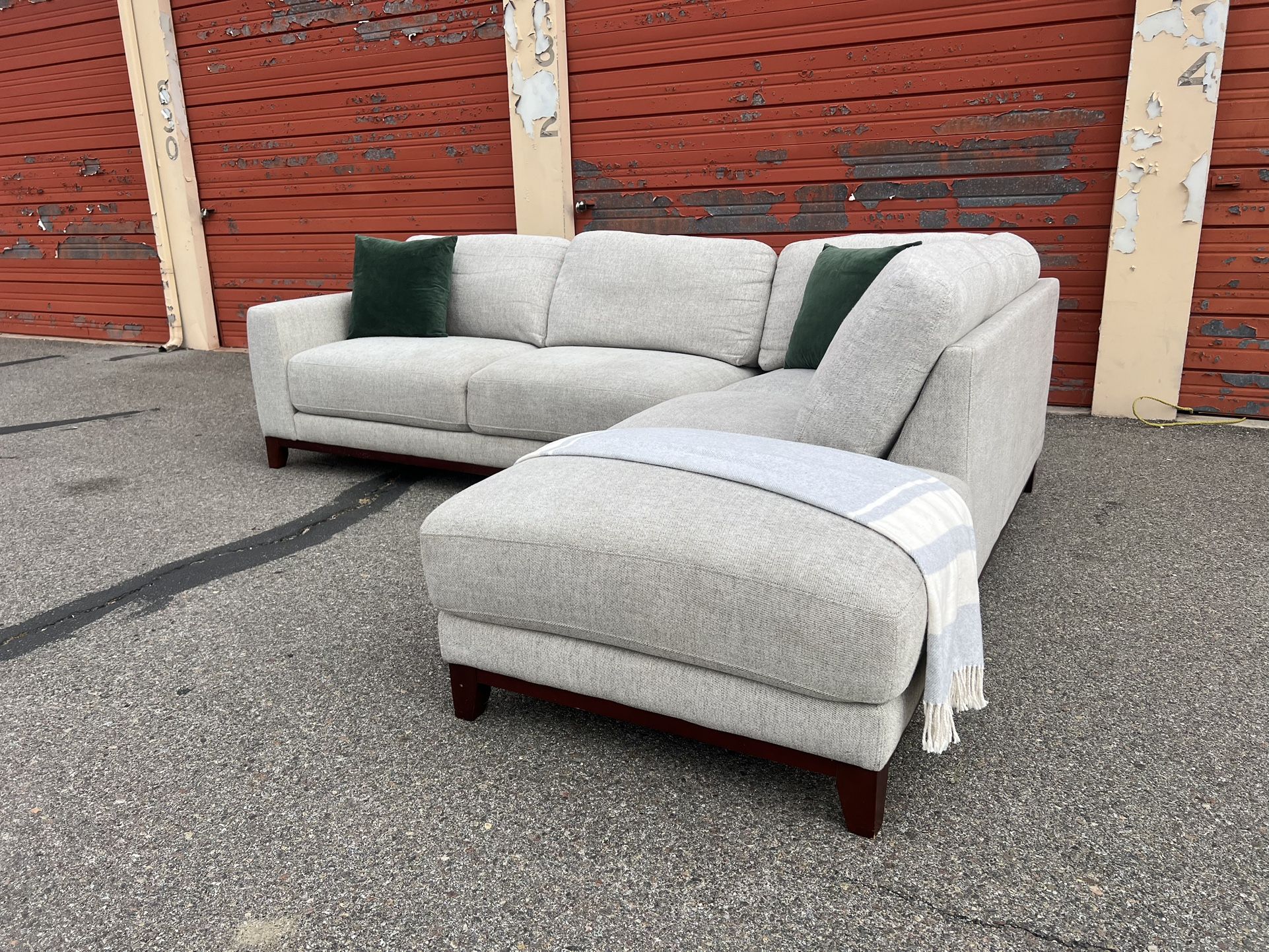 Gray Living Spaces sectional sofa couch with right facing chaise