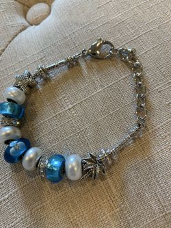 Charm bracelet with blue, white and silver beads