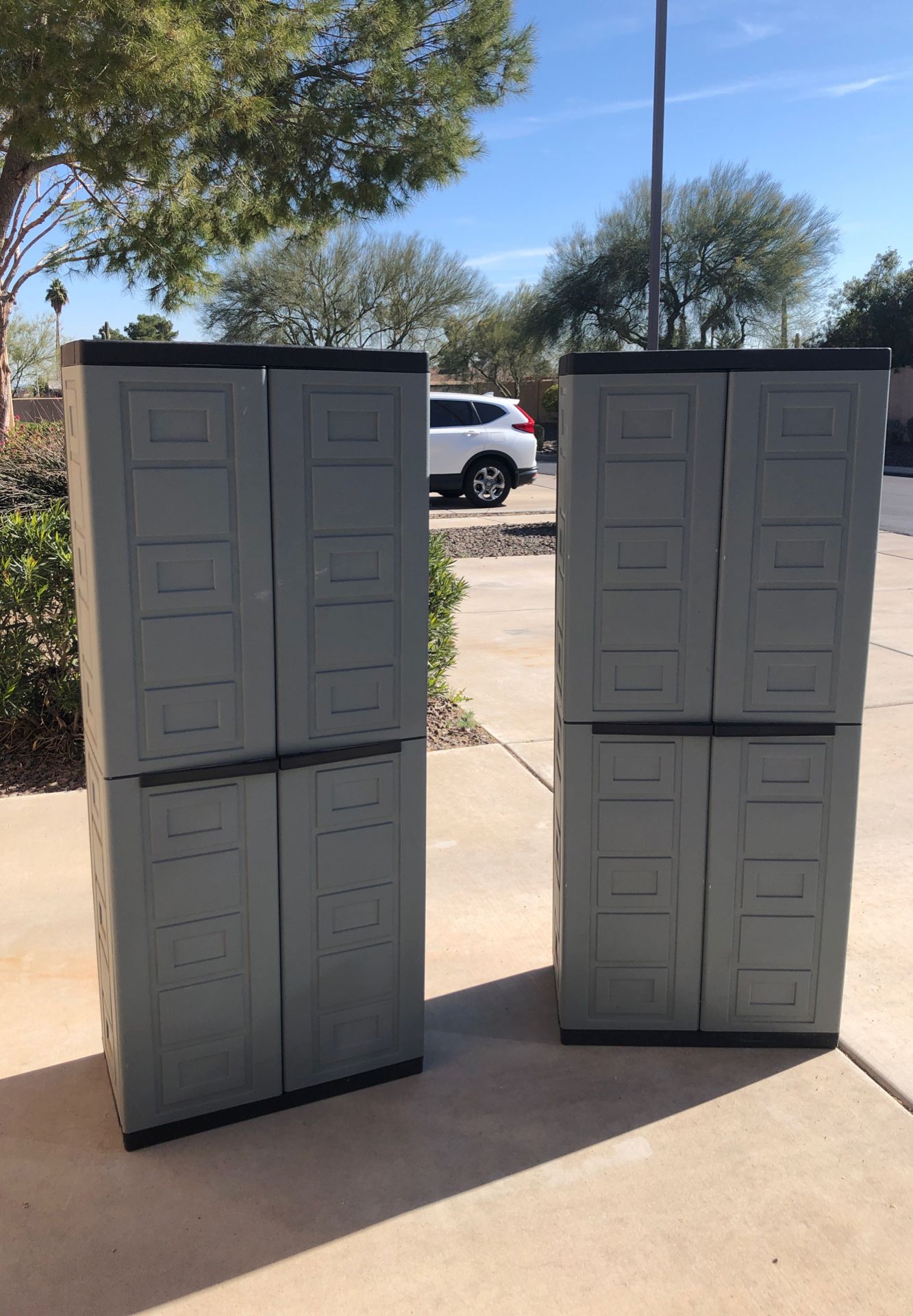 Two plastic storage cabinets with shelves