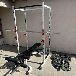 Bench press/squat rack with 7ft 45lbs bar plus 230lbs of Olympic weights and curl bar