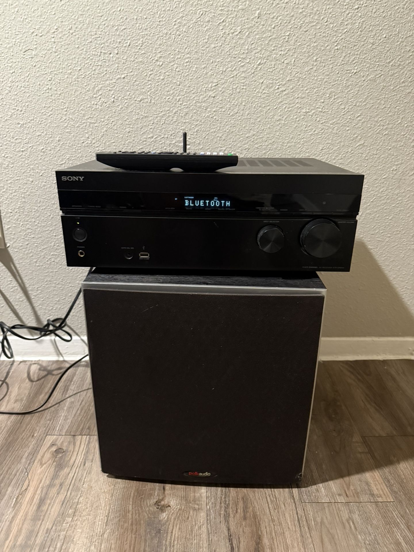 Sony 7-channel receiver with its original control and a Polk audio subwoofer works very well.