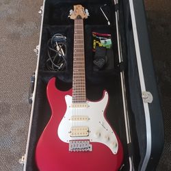 Greg Bennett electric red guitar with shoulder strap and tuner and cord no amp.  plays great in road runner hard case 