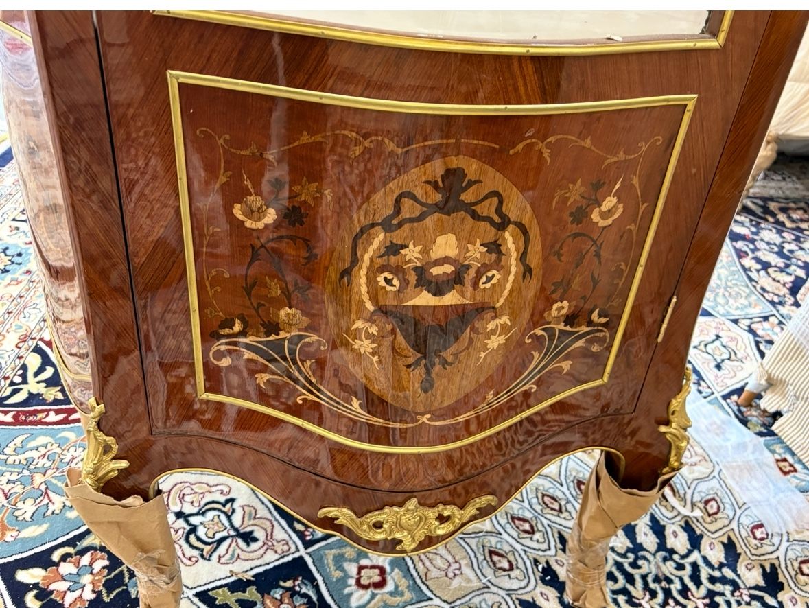 Curio Louis XVI Vitrine LOOK UP This is a Louis XVI style vitrine. TIME PERIOD Late 20th Century ORIGIN France HISTORY This vitrine is crafted in the