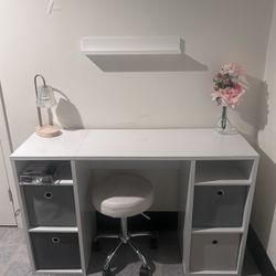 Desk with storage cubes and a roller stool 