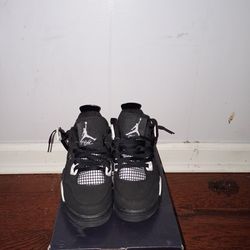 Jordan 4s white thunders and a black Nike jacket