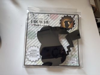 New Pokémon Pikachu LED Wall Light / Night Light – New in Package  Has defects. One side of the box seal has yellow tape. See back photo   Cute offici