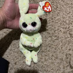Ty Beanie Bellies "Fern" the green Easter Bunny plush toy, part of a collectible series known for their soft bodies and large, glittering eyes.  Featu